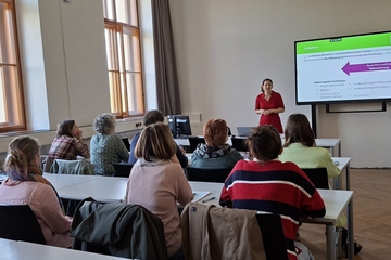 Personen sitzen an Tischen