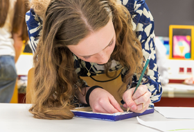 Eine Frau schreibt auf einem Zettel 