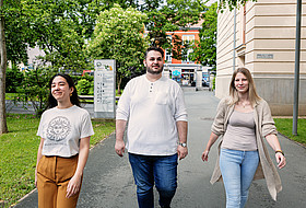 3 Personen gehen einen Weg entlang
