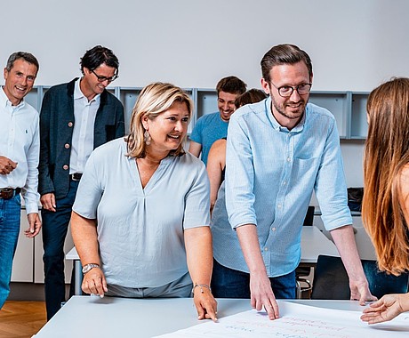 Personen arbeiten an Plakat