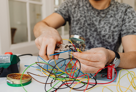 Mann arbeitet mit Stromkabeln 